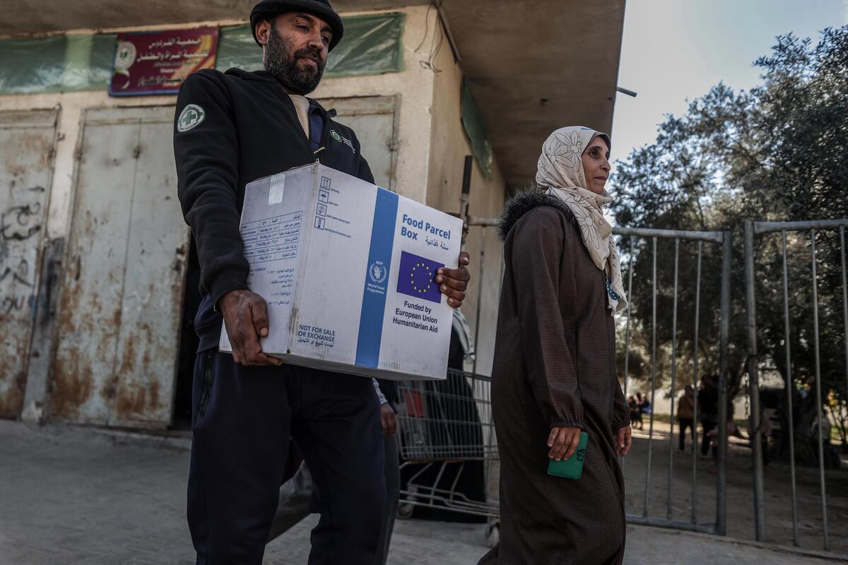 EU food parcel being carried in Gaza