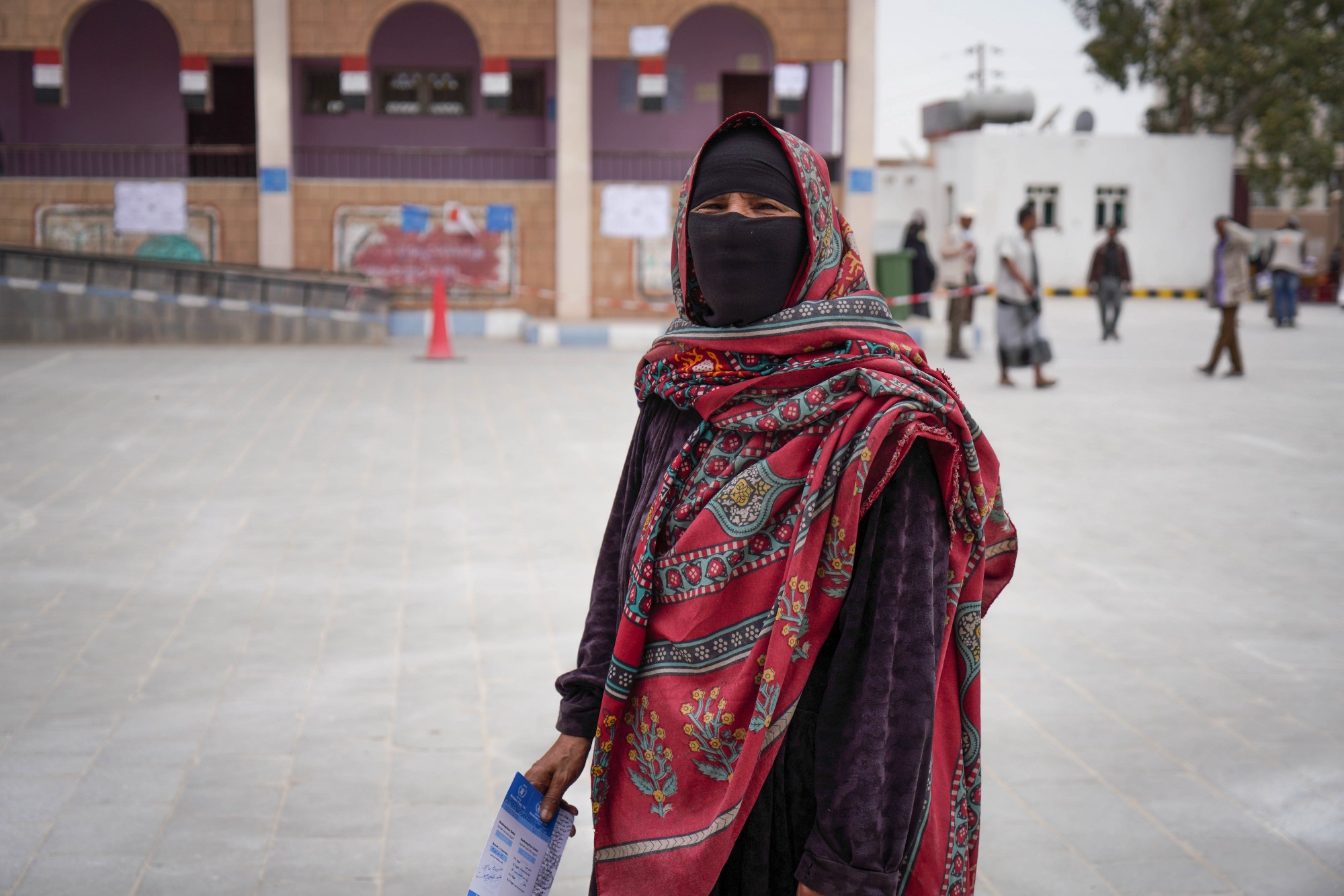 Habiba collects a WFP food voucher