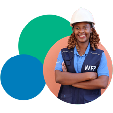 WFP Woman employee wearing a branded vest and helmet