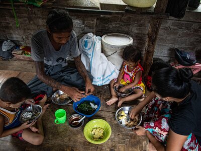 Family of 4 having eating food items distributed by WFP in Yangon as food insecurity rises following the military takeover in early 2021