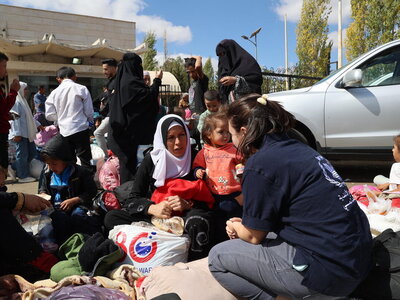 Photo: WFP/Hussam Al Saleh Thousands of Lebanese and Syrians flee into war-torn Syria. WFP is providing fortified date bars for the children as the entry procedures are taking long time approximately 2 hours minimum due to the huge numbers arriving at the border