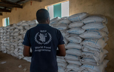 A WFP employee looks at bags of food items before distribution at a general food distribution site in the village of Maikona in Marsabit County, northern Kenya