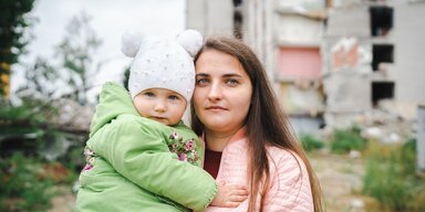 Alina, 27, is the mother of two children aged 1 and 5, living in Chernihiv city. She is holding her child. 