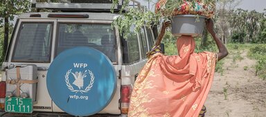 A woman carrying some items on her head