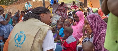 WFP staff addressing a woman