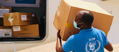 WFP staff loading boxes on plane