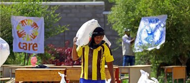 Man carrying a sack of food item