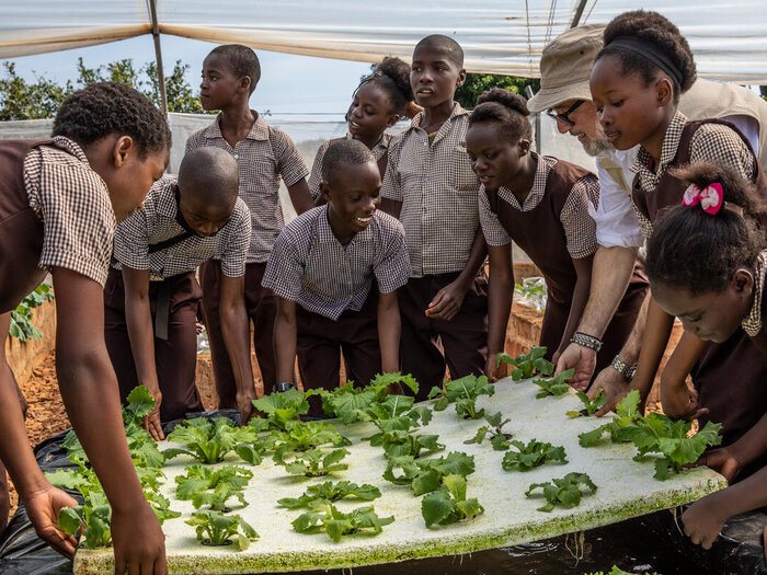 WFP's Goodwill Ambassador Andrew Zimmern speaks with students on how they manage the hydroponics garden in Gwembe Primary School.