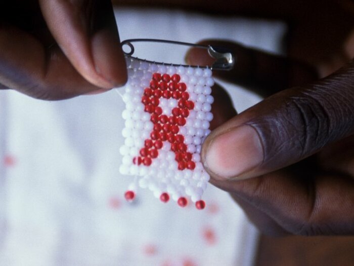 HIV symbol knitted on a safety pin