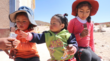 three little girls eating quinoa snacks