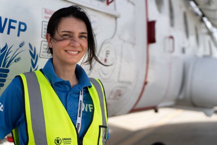 a woman in front of an airplane