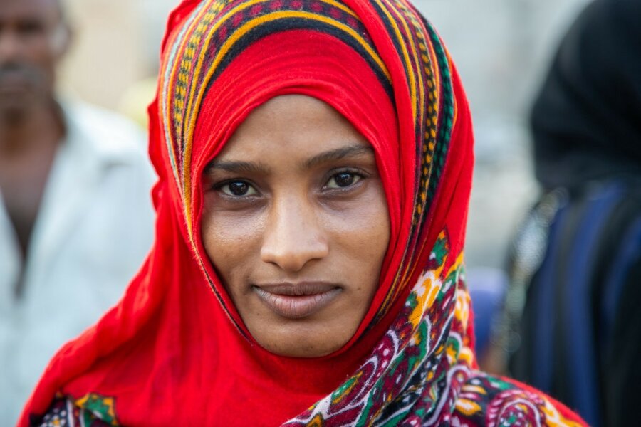 a woman is smiling at camera