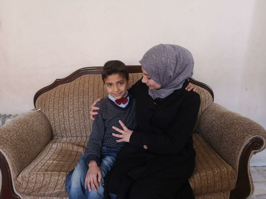 Abdulrafea in the arms of his mother