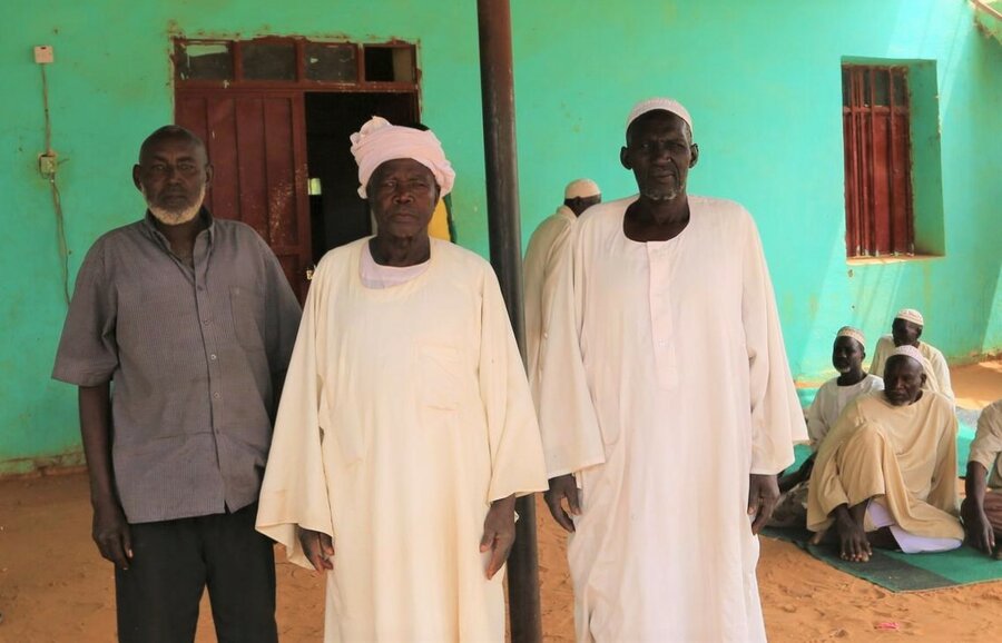 A group of elders who were displaced from the Krinding camps following clashes in January are pictured near their temporary shelters outside the State Ministry of Welfare in Geneina. 