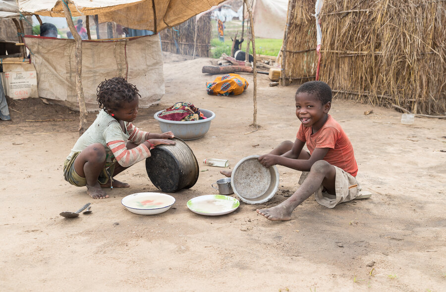 Children play with pots and pans in 25 de Junho