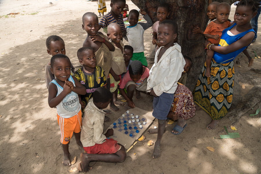 Children play a homemade board game 