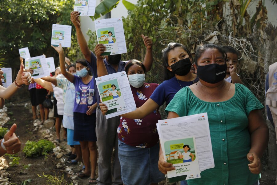 Row of women holding pieces of paper