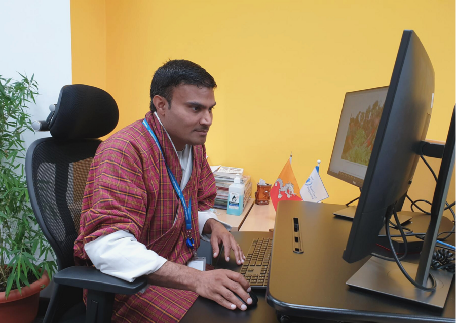 Man sat at work desk looking at computer