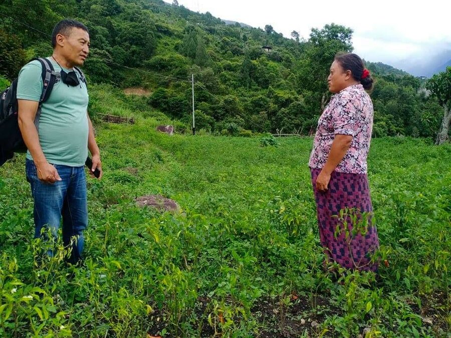 Man and woman talking in field