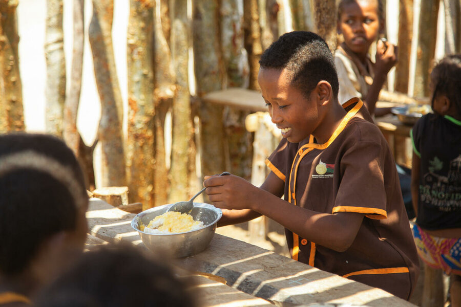  Séraphin smiles as he eats rice and lentils in the canteen. Séraphin is a beneficiary. 