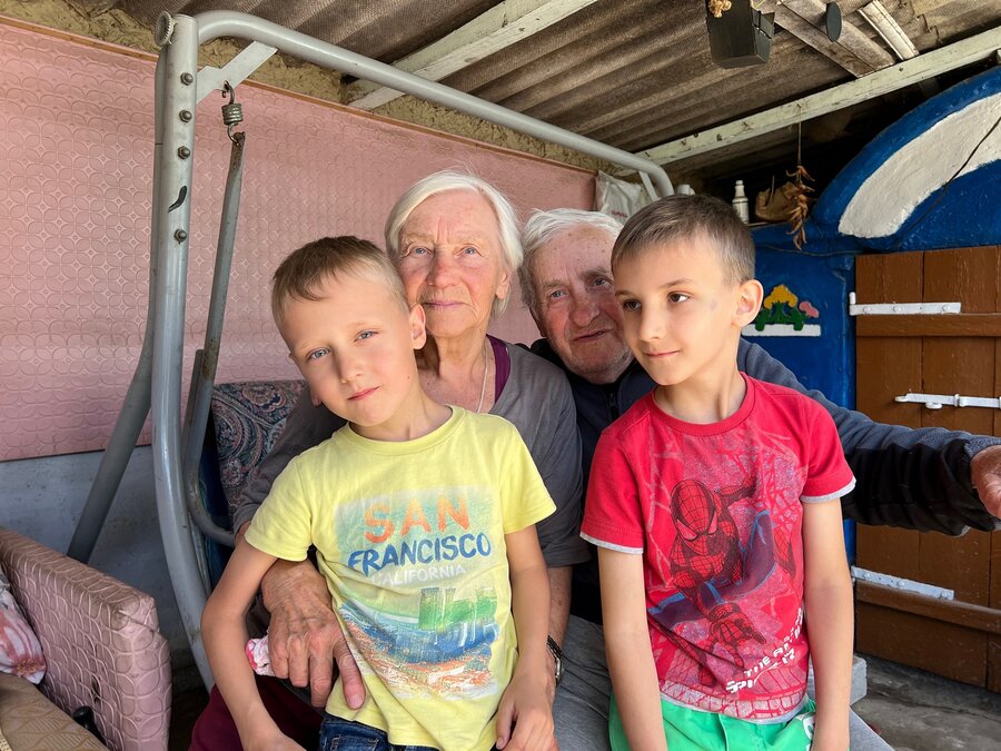 Grandparents sit with 2 boys