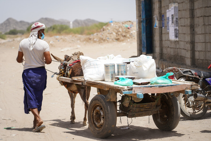 Man leading cart away carrying food