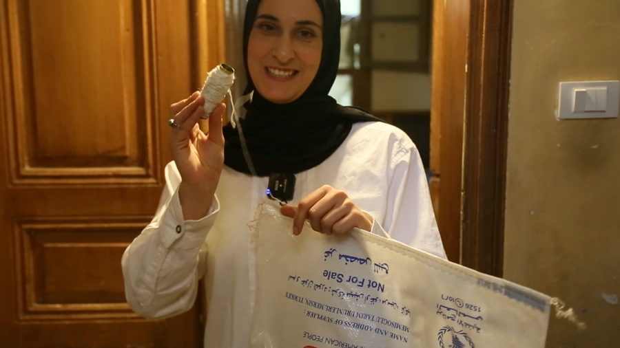 Kawthar uses the thread from the bag to sew parts of her furniture. 