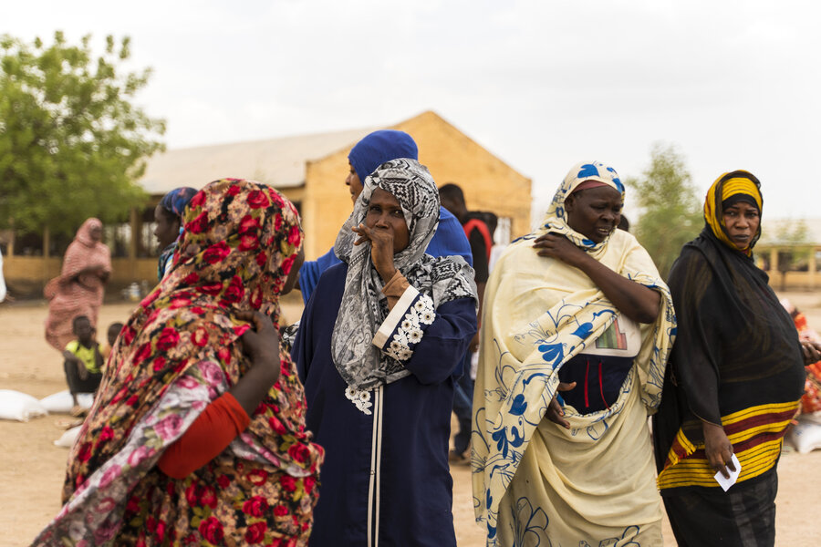 Women in Wad Madani, Gezira State await a WFP food distribution in June