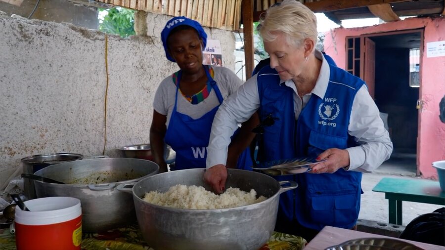 WFP Executive Director Cindy McCain (R) helps dish up school meals during a visit to Haiti. The country's hunger crisis is 