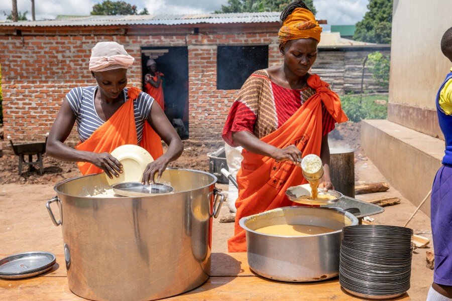 Women at Saint Bakhita Primary dish up WFP school meals that include produce from the school's garden. Photo: WFP/Eulalia Berlanga