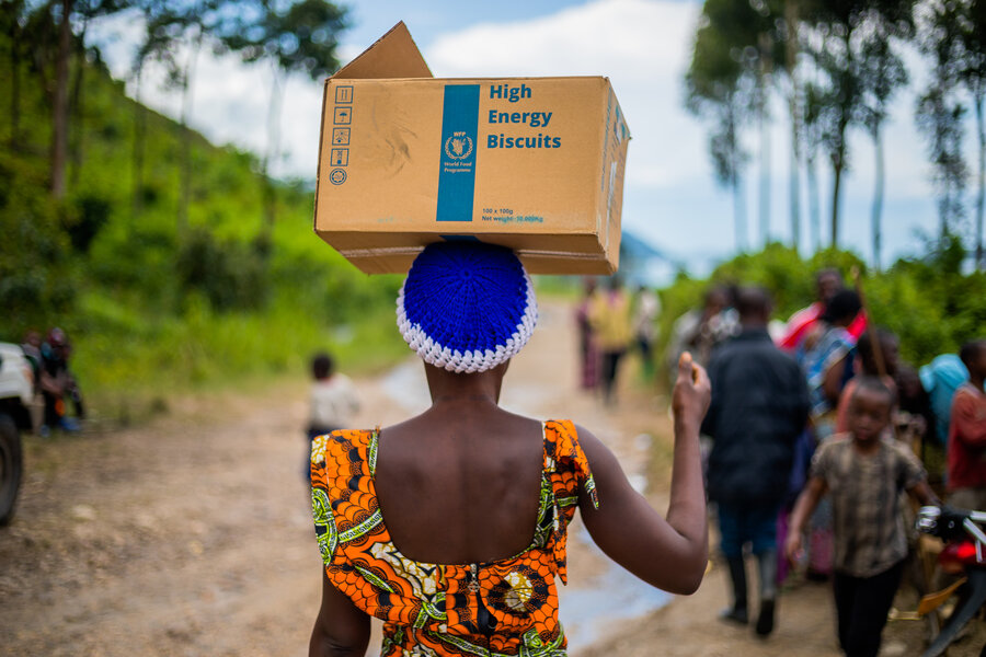 Woman carrying box of food on her head