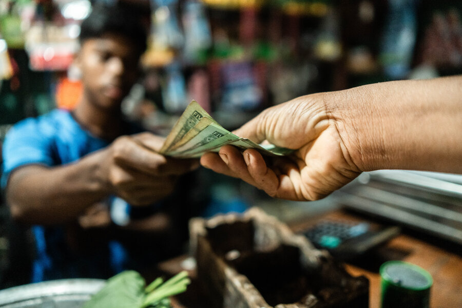 A man handing banknotes to someone