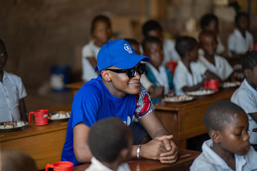 Innoss'B poses in class with children at a school Kalemie