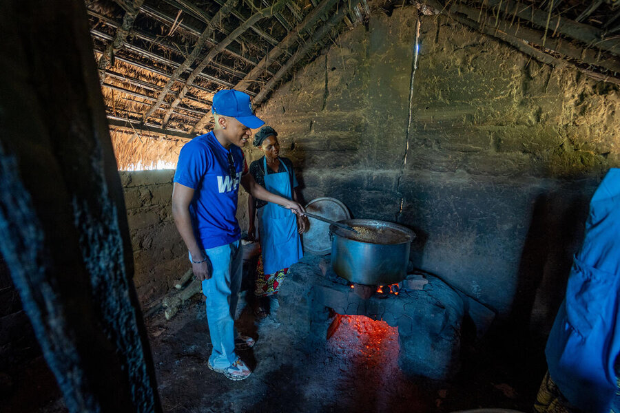 Innoss stirs a cooking pot at a school in DRC