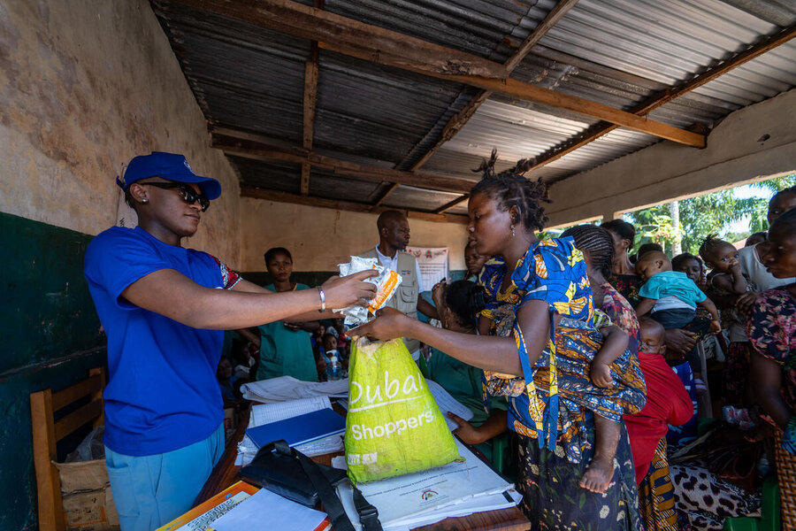 Innoss B assists at a distribution in Kalemie