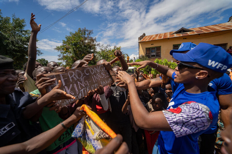 Innoss'B signs autographs for fans gathered outside a WFP-supported health clinic in Kalemie
