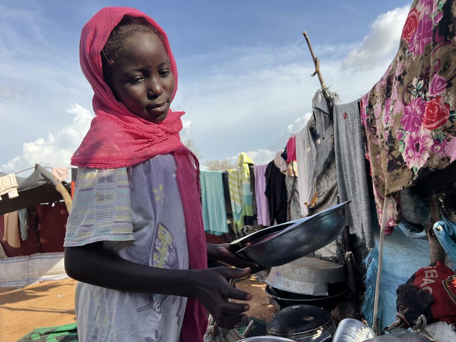 Instead of studying, Sudanese refugee Samar fetches water and mills sorghum at a refugee settlement in Chad so her family can survive. Photo: WFP/Leni Kinzli