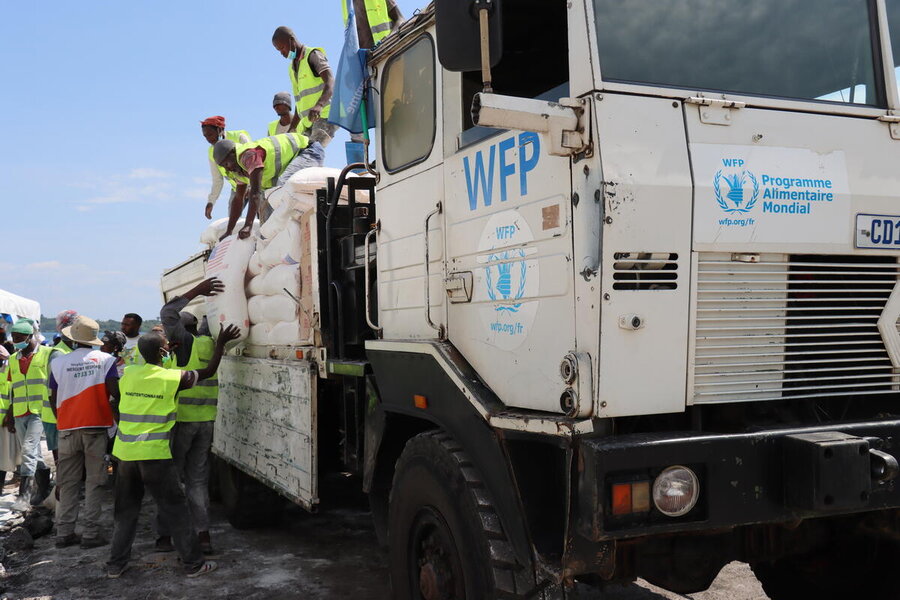 Workers unload food from WFP trucks at the Bulengo camp for displaced people, just outside North Kivu's provincial capital of Goma. Eastern DRC is a patchwork of territories controlled by armed parties WFP must navigate. Photo: WFP/Shelley Thakral