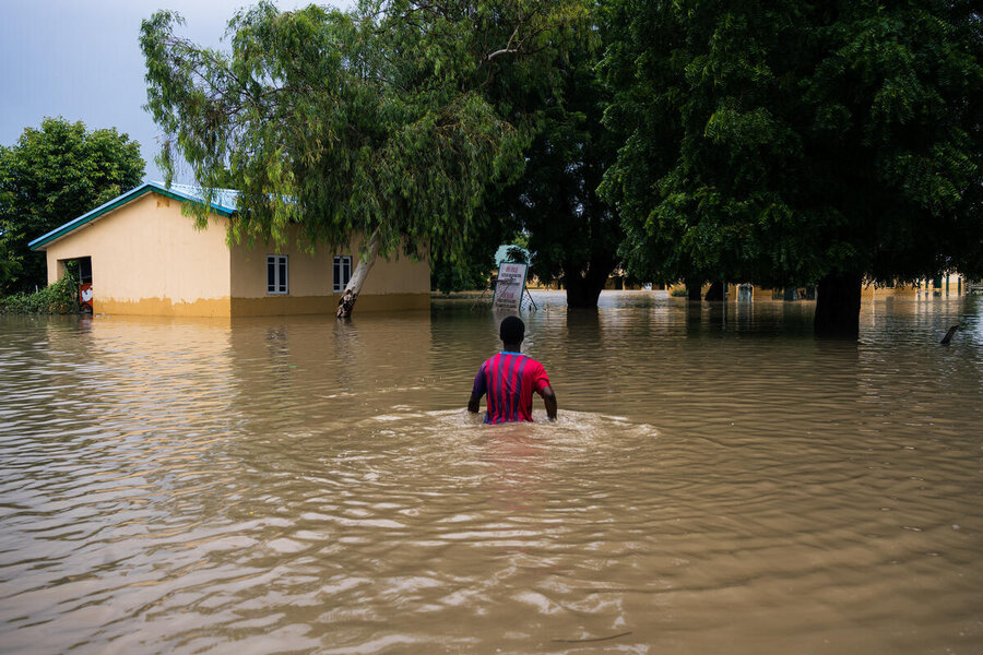 A man wades through floodwaters in Maiduguri, in northern Nigeria. Flooding in swathes of West and Central Africa have boosted hunger in the region. Photo: WFP/Ozavogu Abdul