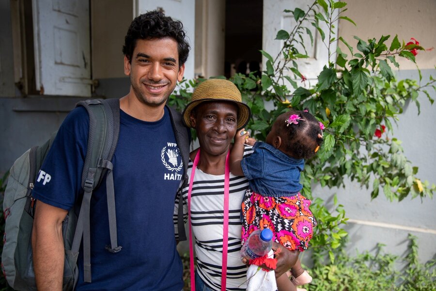 WFP Haiti Communications Officer Pedro Rodrigues with Rose and her daughter, who participated in a WFP-supported infrastructure project - and offered us some shade from Haiti's intense sun. Photo: WFP/Theresa Piorr 