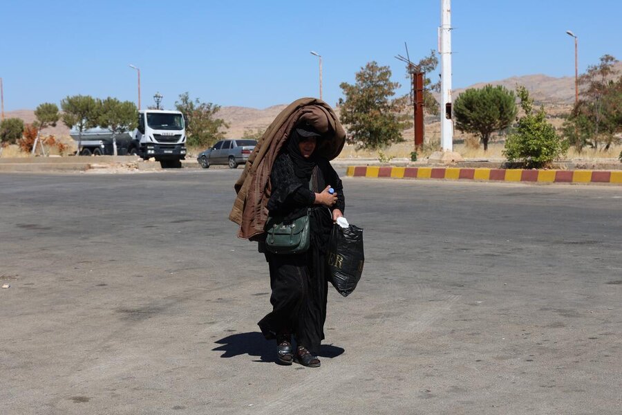 A woman crosses into Syria from Lebanon, where the escalating conflict has displaced more than a million people. Photo: Hussam Al Saleh