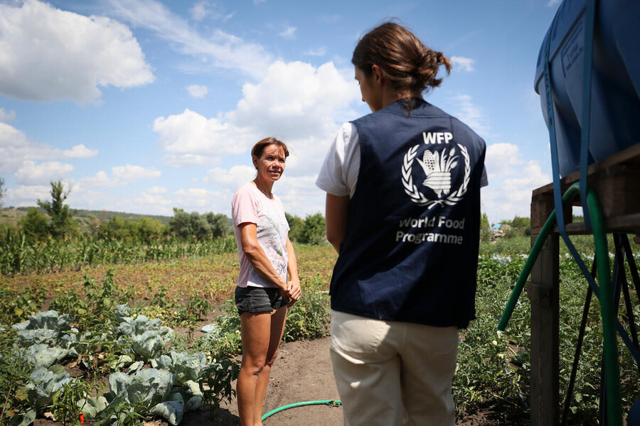 In Ukraine's Kharkiv region, Tetiana (L) chats with WFP staff member Polina Hlushko. Tetiana received de-mining support thanks to a WFP programme implemented in partnership with a specialist de-mining organization. WFP/Antoine Vallas