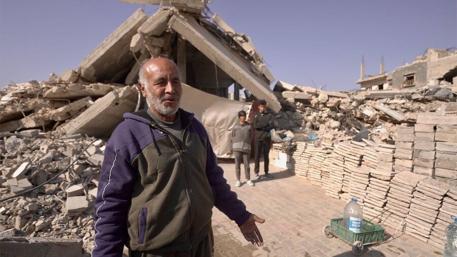 Abu Bilal shows WFP's Jon Dumont his precarious shelter, built under two concrete slabs from his former apartment building. WFP