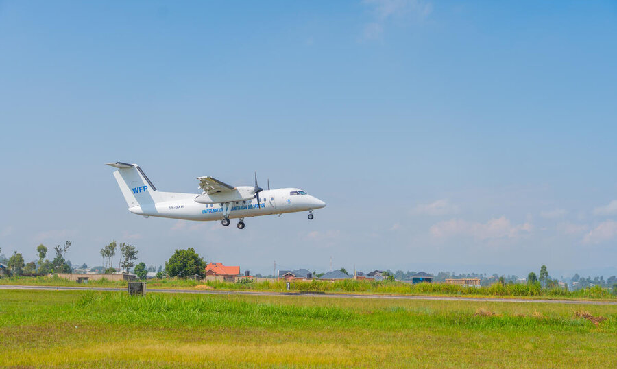 A WFP-marked plane lands on a country runway