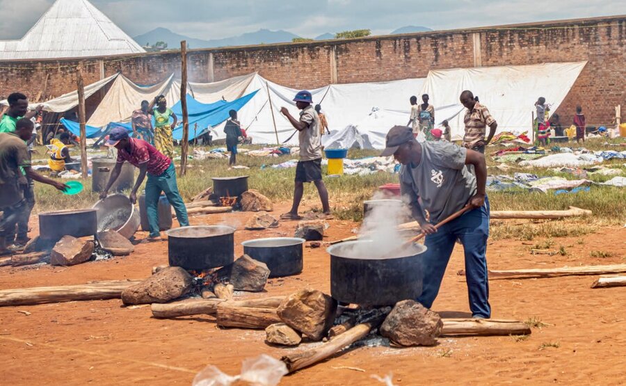 Cooks in Rugombo, Burundi, stir pots of WFP-provided rice and split peas for the influx of Congolese. WFP/Colombe Ishimwe