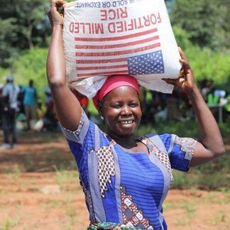 A woman holding a bag of food 