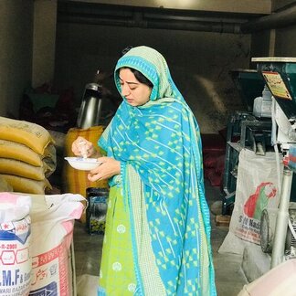 Woman standing among supplies of food