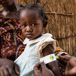 Mantapala Refugee Settlement, Nchelenge district, Zambia. A toddler is screened for malnutrition. Photo: WFP/Vincent Tremeau