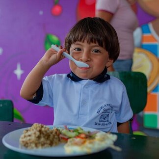 A child eating a school meal