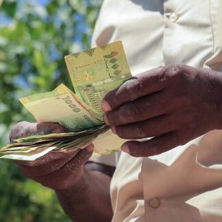 Close-up of man counting out money